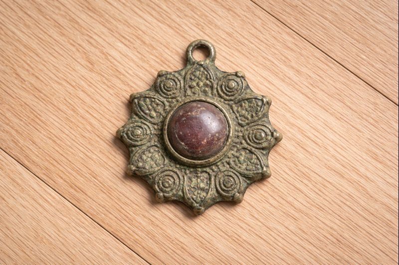 Bronze Sunburst Amulet with Central Stone – thumbnail